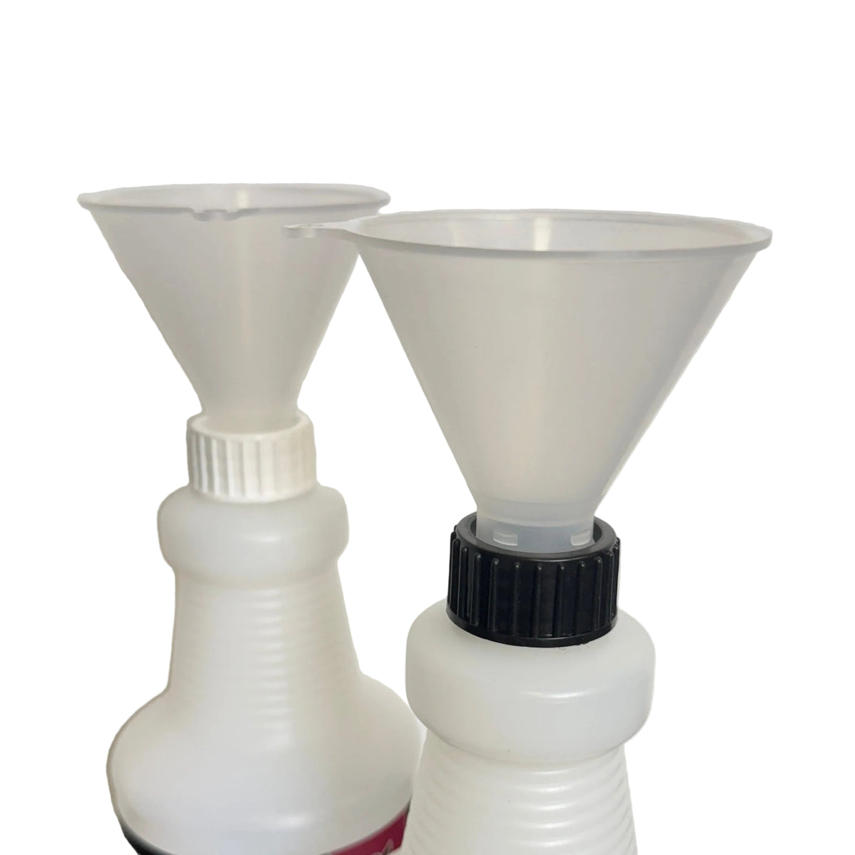 Two white plastic spray bottles with funnel tops, one with a black cap and one with a white cap, on a dark surface against a light background.